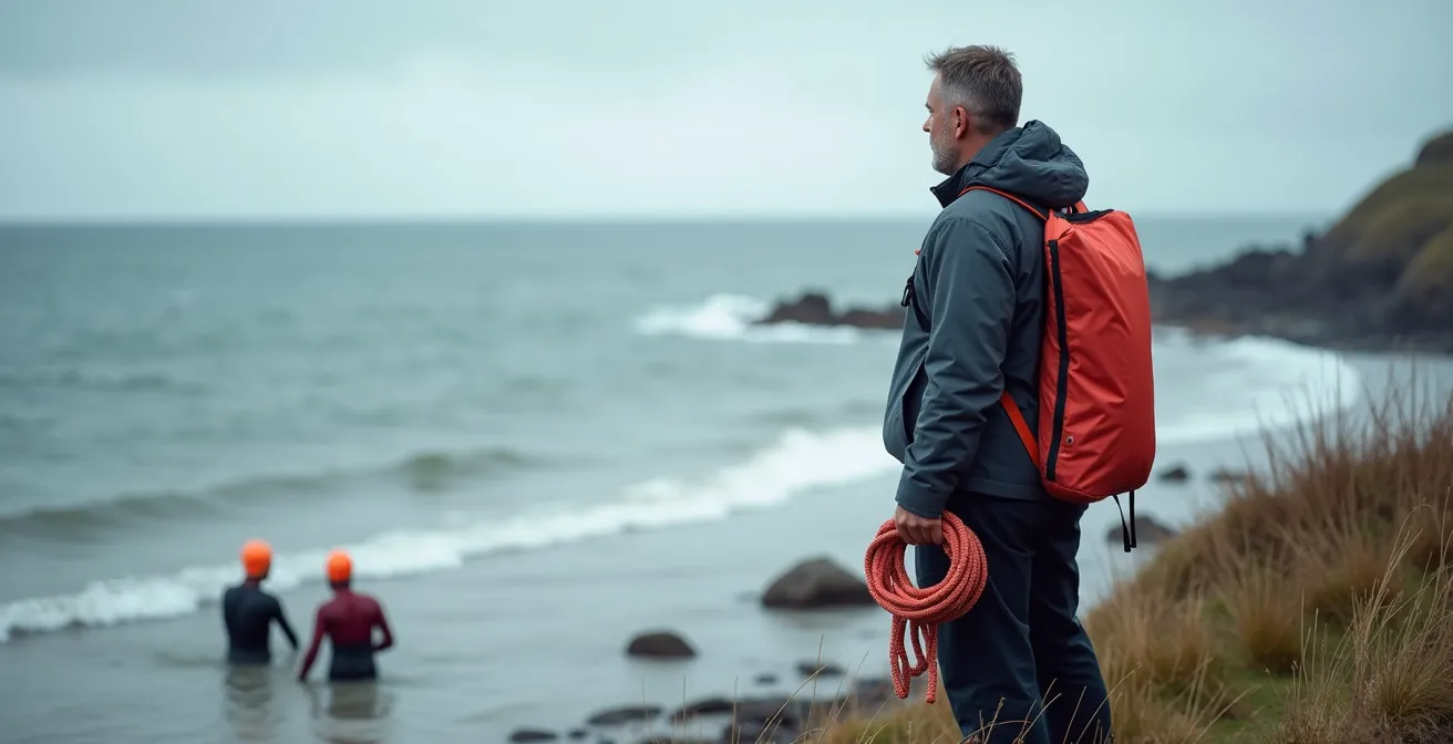 Shore spotter watching swimmers from Atlantic beach with safety equipment